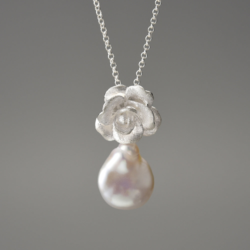 
                  
                    Necklace-And-Camellia-Pendant-With-Baroque-Pearl_By-Yonandole_4
                  
                