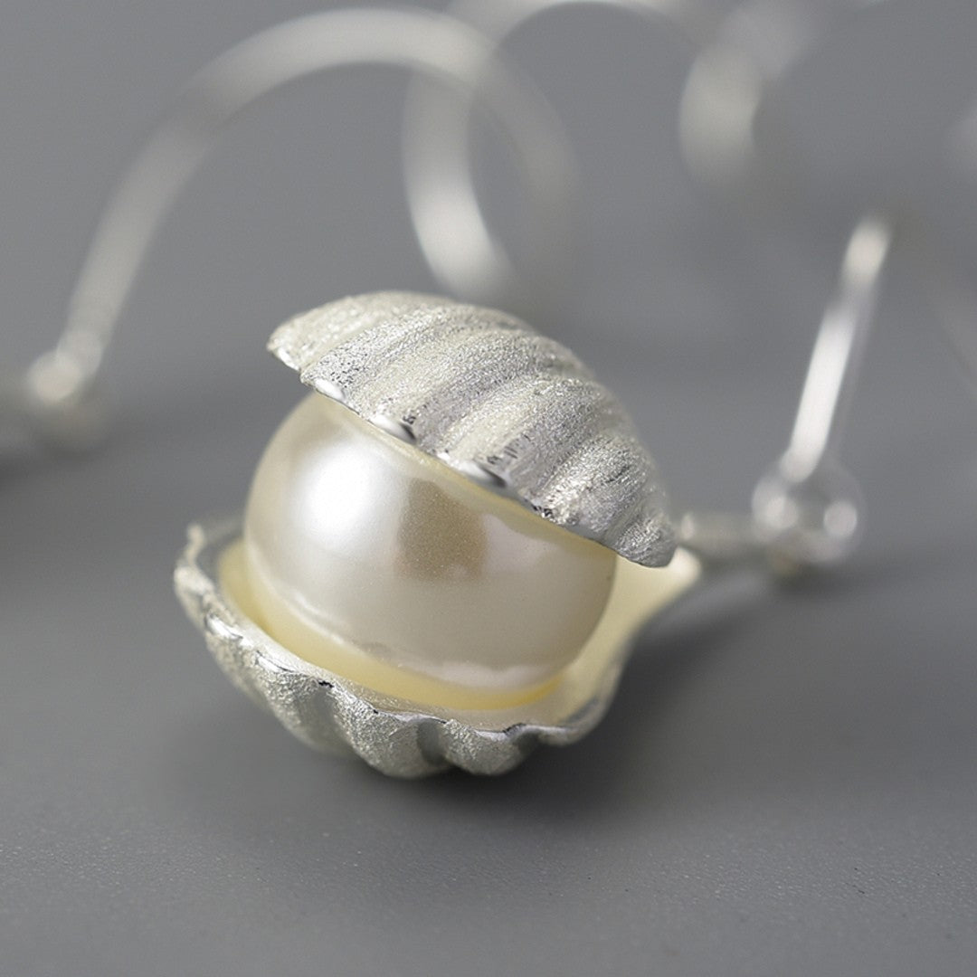 Wire-Earrings-With-Mother-Of-Pearl-Bead-In-A-Shell-Setting-By-Yonandole_3